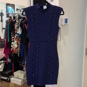 Navy blue, mini length. Gunmetal details. Mock neck, padded shoulders.